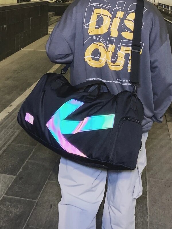 Man carrying a letter-patterned duffel bag from Shein