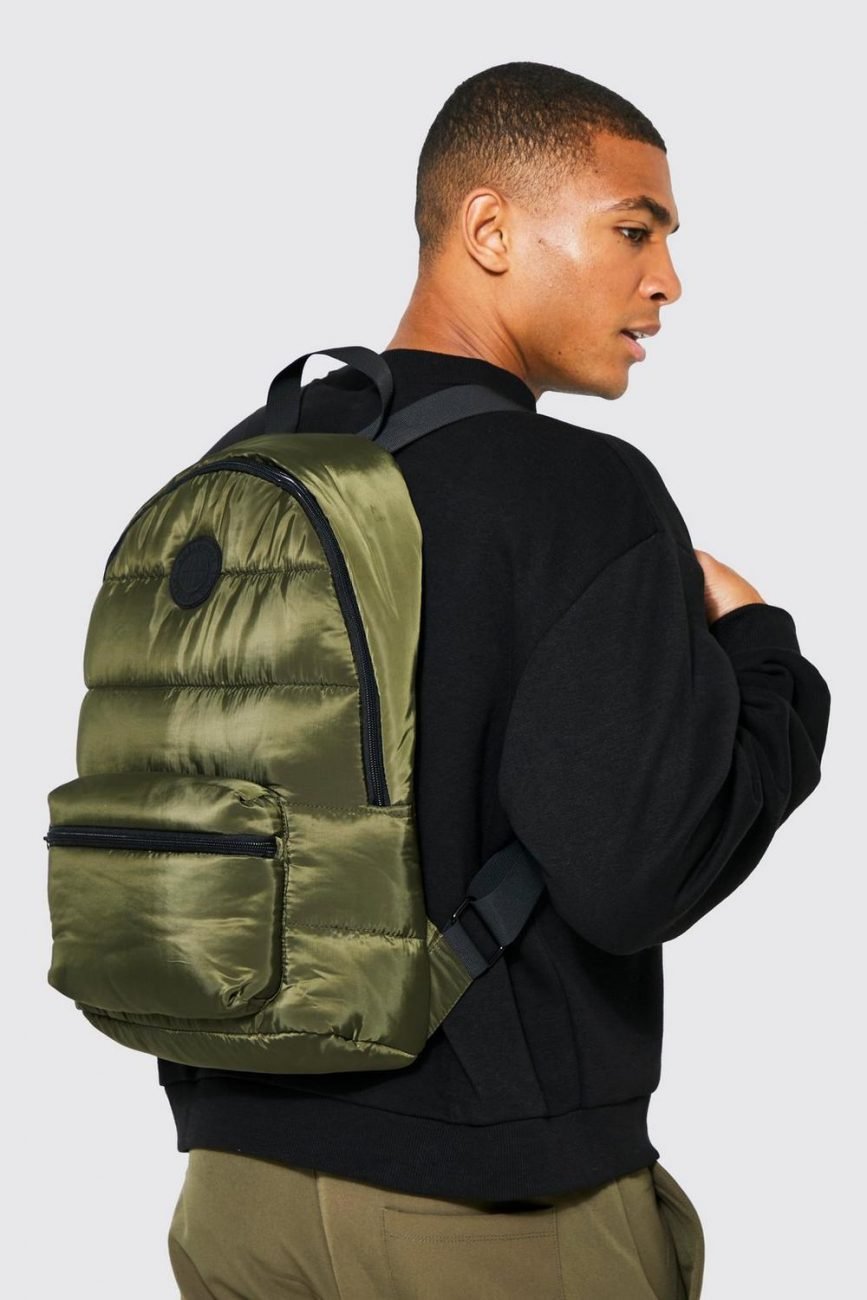 Man wearing a khaki padded backpack