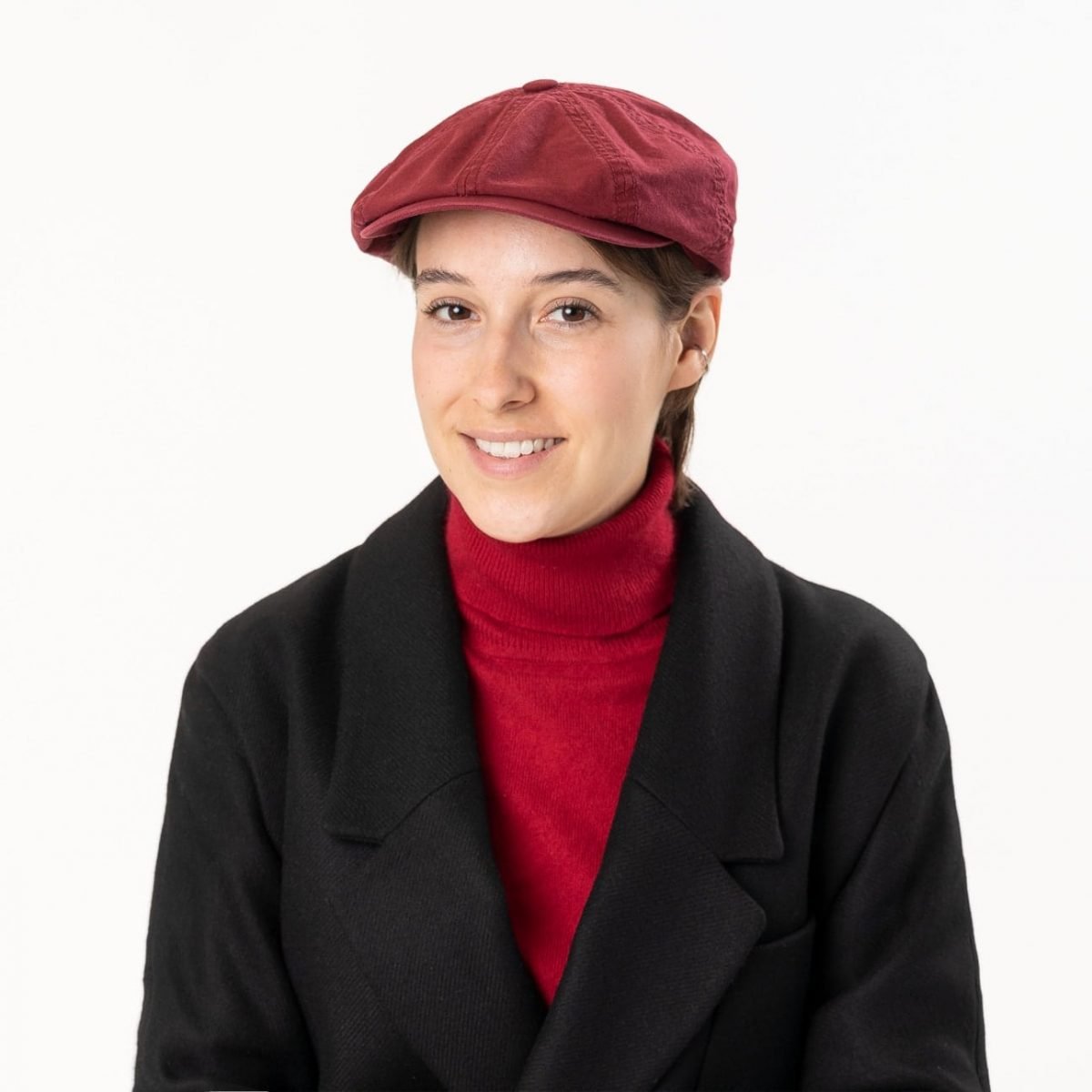 Woman wearing a red Hatteras cap