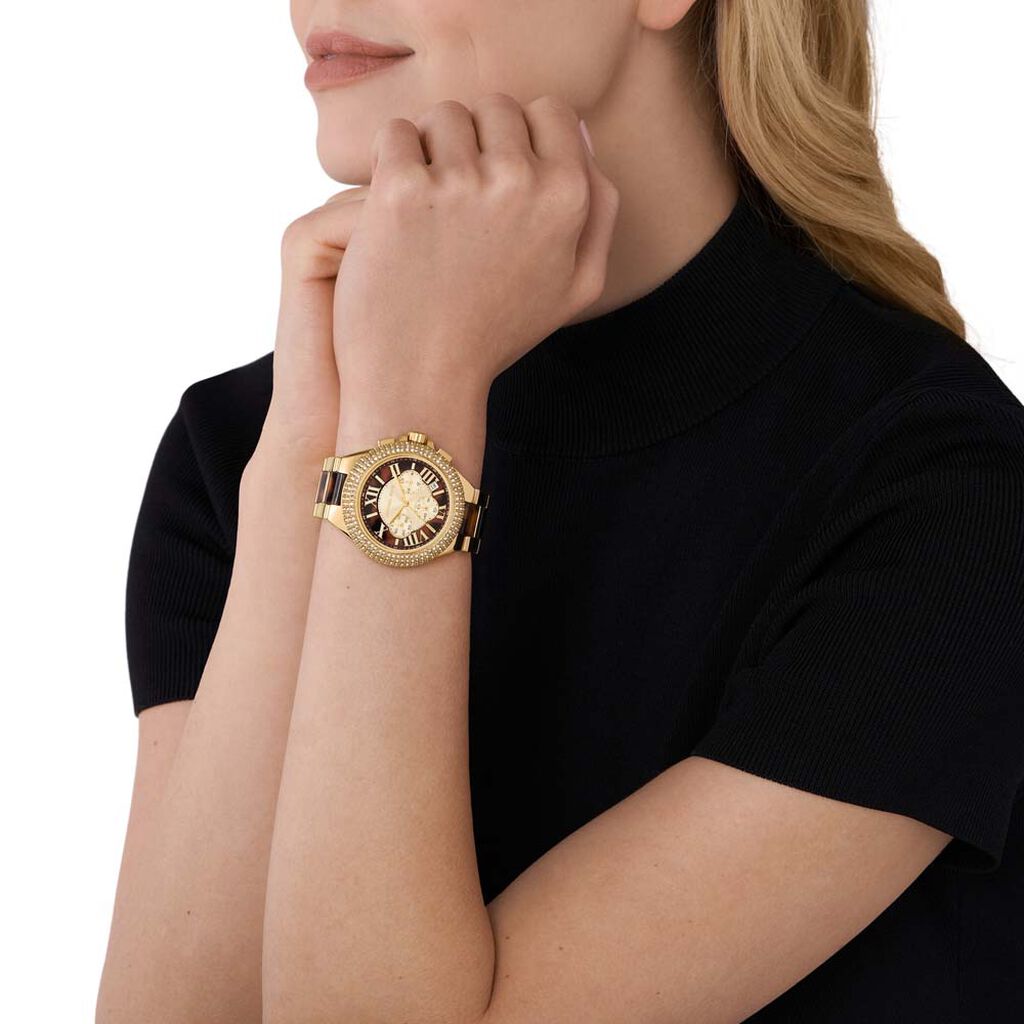 Woman wearing a brown watch from Michael Kors