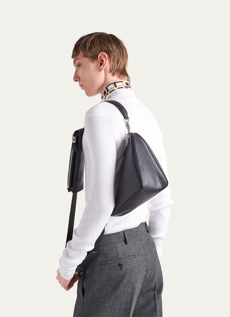 Man wearing a black leather Saffiano shoulder bag by Prada