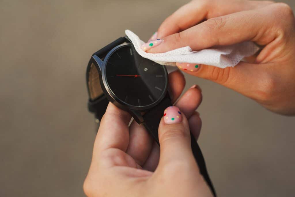 Maintaining the women's watch by cleaning it with a microfiber cloth