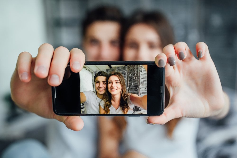 A couple taking a selfie with a phone