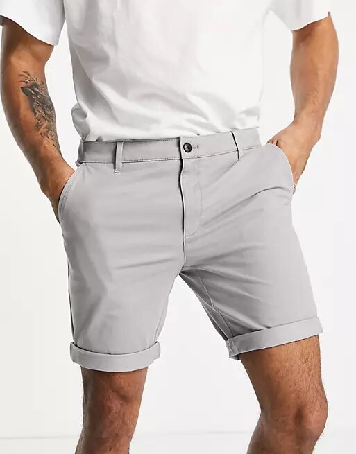 A man wearing light gray chino shorts