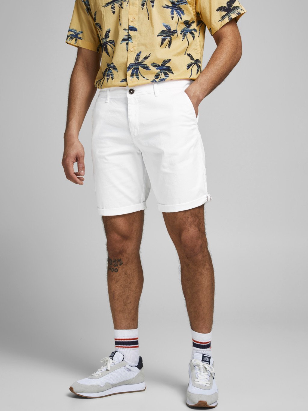 A man wearing white chino shorts