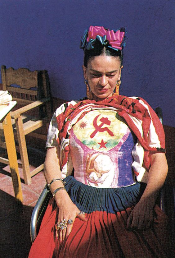 Frida Kahlo showing her painted corset under her huipil