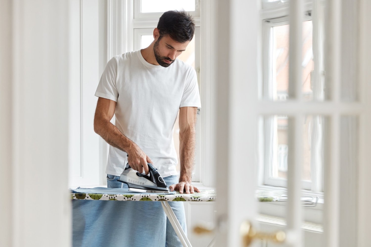 person drying and ironing the cardigan