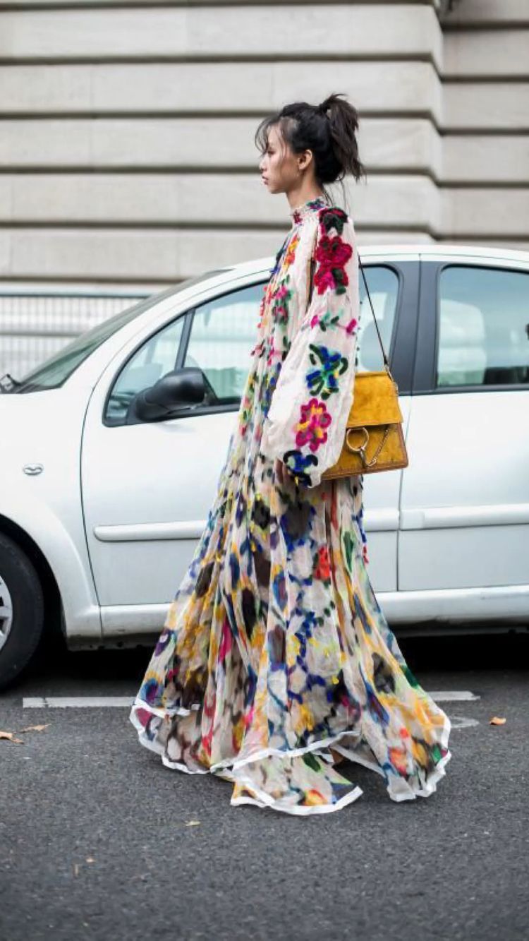 Woman wearing a long floral dress on the street