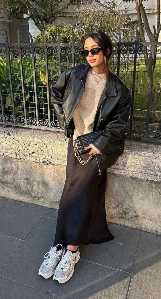 Combination of leather jacket and brown skirt